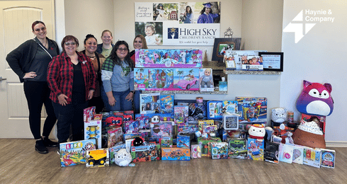 Haynie Volunteers Posing with Donated Gifts at High Sky Children's Ranch Toy Drive