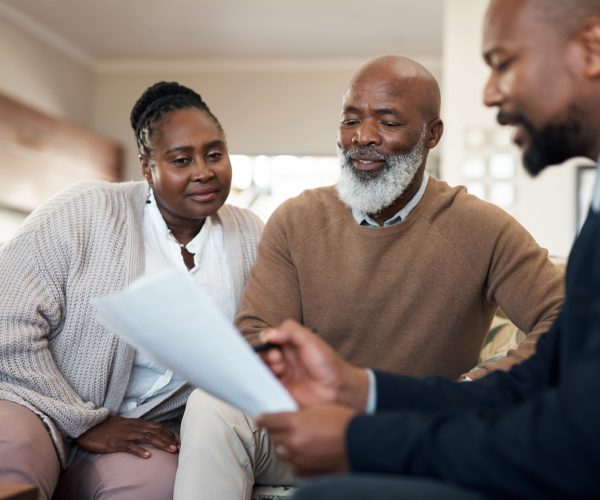 Mature, senior and married couple and a finance manager looking at retirement, savings and investment paper work. Man and woman planning a budget for their future with an accountant, banker or broker