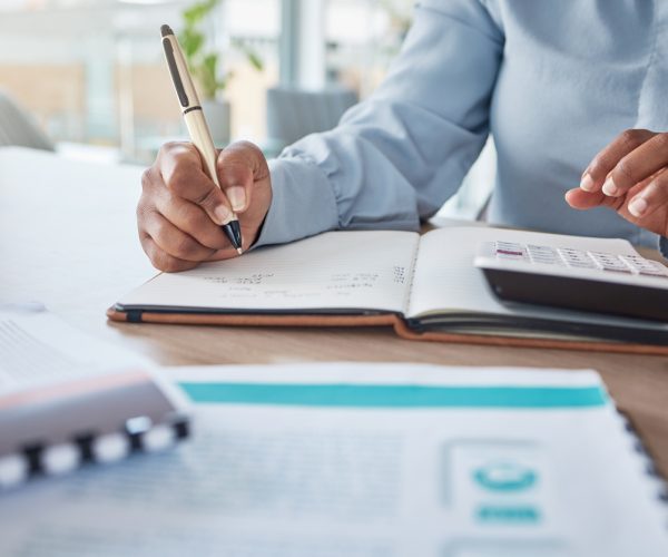 Woman in accounting, payroll, tax, credit and bank payment for startup company in an office. Businesswoman, finance and data, with a calculator, working out balance for corporate account at her desk