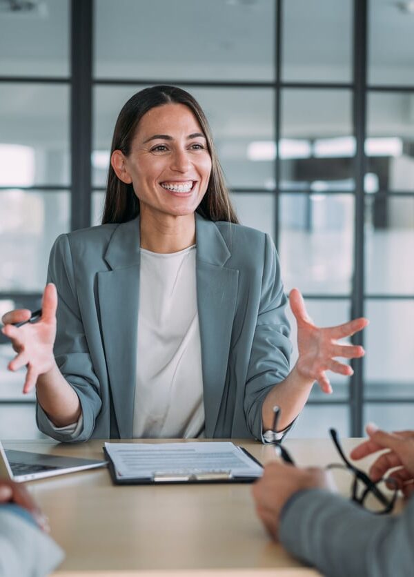 Shot of group of business persons in business meeting. Three entrepreneurs on meeting in board room. Corporate business team on meeting in modern office. Female manager discussing new project with her colleagues. Company owner on a meeting with two of her employees in her office.
