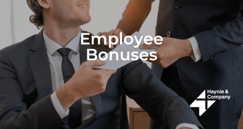 Businessman receiving a bonus envelope from a colleague at Haynie.