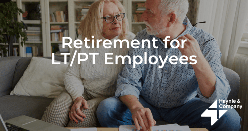 Elderly couple discussing retirement plans with documents on the sofa.