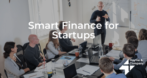 Smart finance workshop for startups with a presenter and participants in a meeting room.
