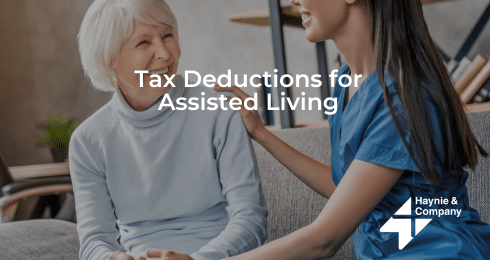 Elderly woman smiling at caregiver, text: Tax Deductions for Assisted Living with Haynie logo.