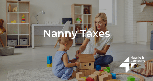 Woman playing with a toddler surrounded by toys in a cozy room.