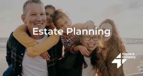 Estate planning with a happy family group on a beach, Haynie logo visible.