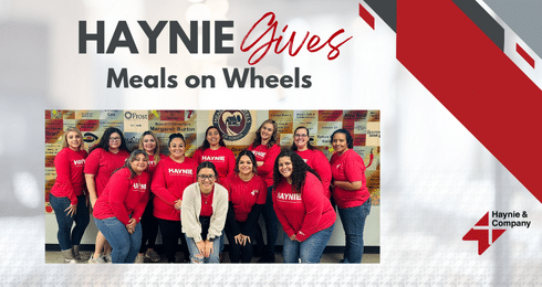 Haynie team in red shirts supporting Meals on Wheels initiative.
