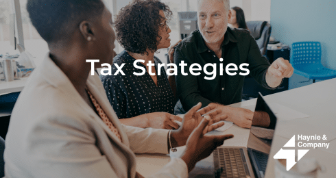 Business meeting discussing tax strategies at Haynie office.