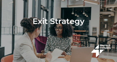 Two professionals discussing exit strategy in a modern office setting.