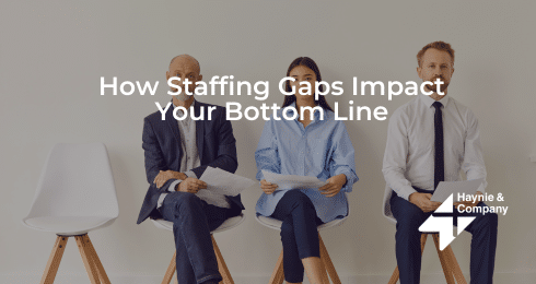 Three people seated holding papers in a business setting, caption overlay on staffing gaps.