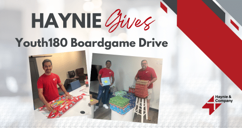 Haynie Gives Youth180 Boardgame Drive with two men wrapping gift boxes.