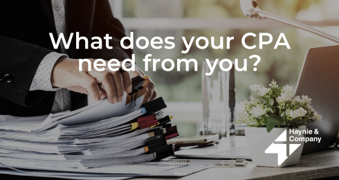 A person organizing documents, text What does your CPA need from you? with Haynie logo.