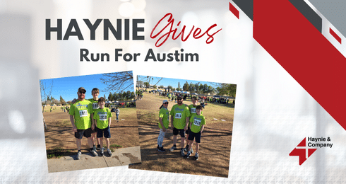 Group in green shirts at the Haynie Gives Run For Austin event, outdoors with a clear sky.