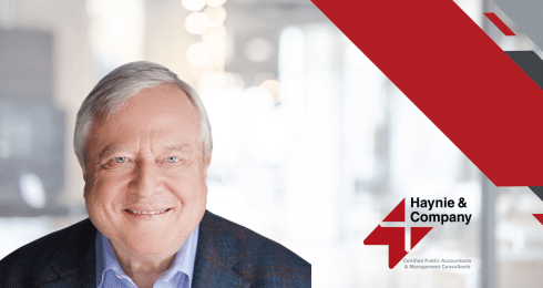 A man smiling with a Haynie logo in a professional setting.