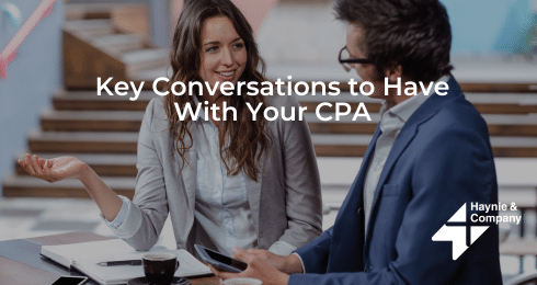 Two professionals having a discussion, titled Key Conversations to Have With Your CPA, Haynie logo.