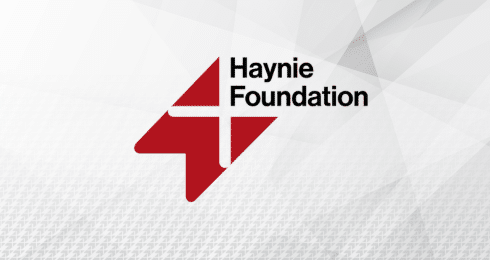 Haynie Foundation logo with red and white geometric design on a textured gray background.