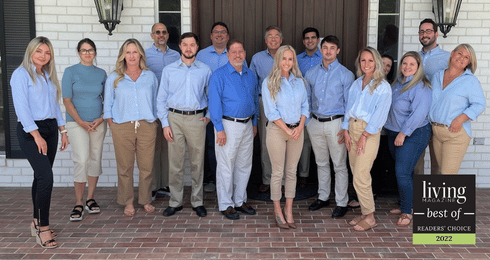 Group of people in blue shirts posing for Living Magazine's 2022 Reader's Choice.