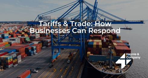 Cargo ship and containers at port with text Tariffs & Trade: How Businesses Can Respond.