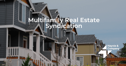 Row of modern homes illustrating multifamily real estate syndication by Haynie.