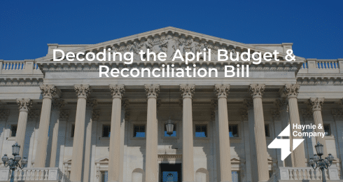 Exterior of a government building labeled Decoding the April Budget & Reconciliation Bill by Haynie.