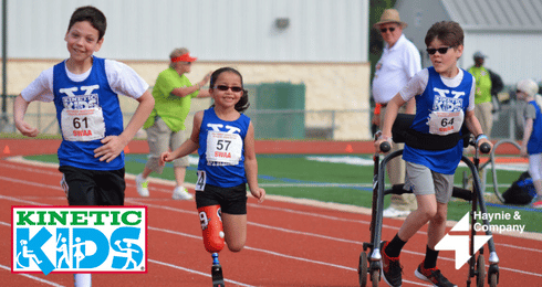 Kinetic Kids race with children running on track, showcasing perseverance and teamwork.