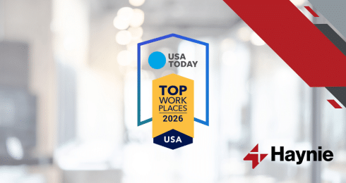 USA Today Top Workplaces 2026 award badge with Haynie logo on a blurred office background.