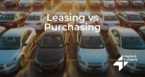 Cars parked in a lot with Leasing vs Purchasing text overlay.