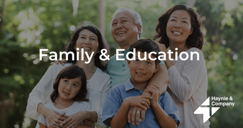 Family smiling outdoors with Family & Education and Haynie logo.