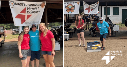 Haynie event with people enjoying outdoor games under a sponsor banner.
