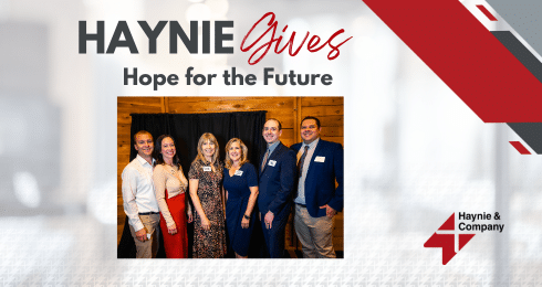 Group of six people at Haynie Gives event, Hope for the Future sign in background.
