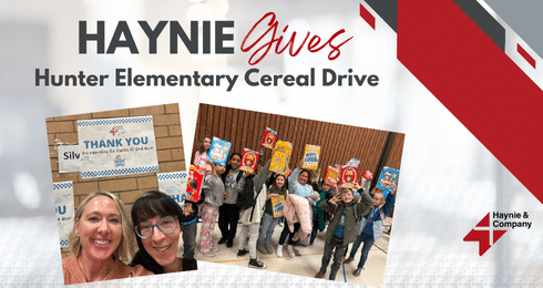 Hunter Elementary students hold cereal boxes at Haynie Gives Cereal Drive event.