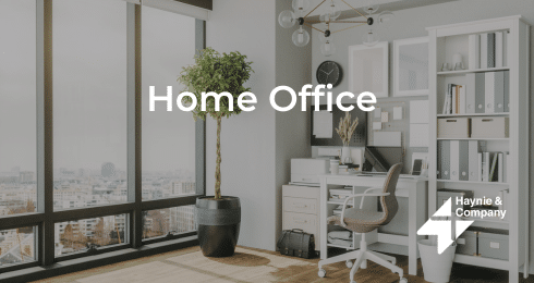 Modern home office with desk, chair, bookshelf, and city view. Haynie branding on the right.