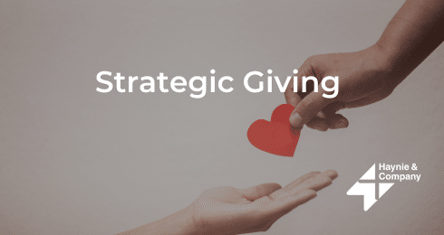 Strategic Giving text with hands exchanging a red heart icon, Haynie logo.
