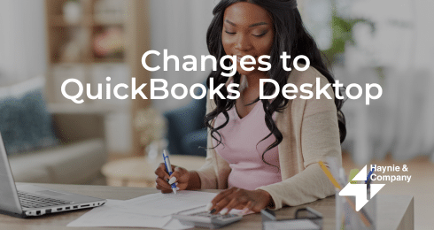 Woman working with QuickBooks Desktop on laptop at home office.
