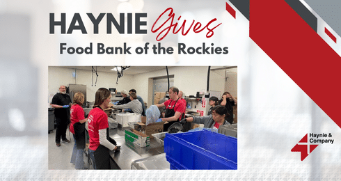 Volunteers packing food at the Food Bank of the Rockies, organized by Haynie Gives.