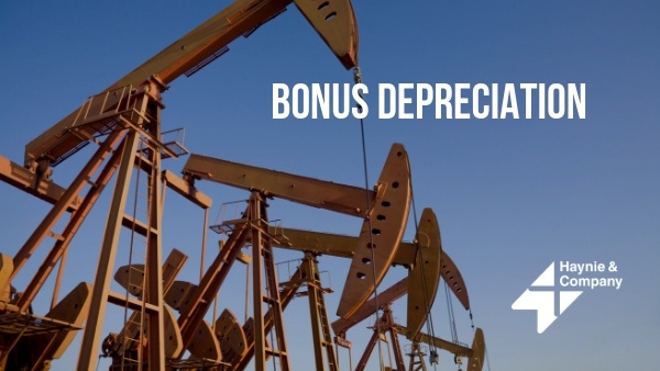 Oil pumps against blue sky with the text Bonus Depreciation and Haynie logo.
