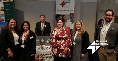 Group of people at Haynie booth during a business event.
