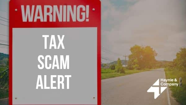 Warning sign for tax scam alert by roadside from Haynie