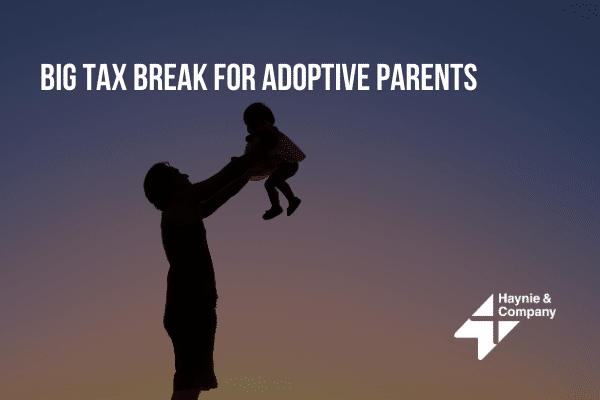 Silhouette of a person lifting a child with text about tax breaks for adoptive parents.