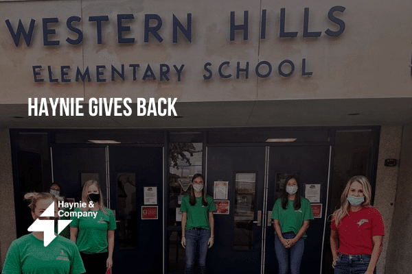 Employees stand in front of Western Hills Elementary School, Haynie volunteer event.