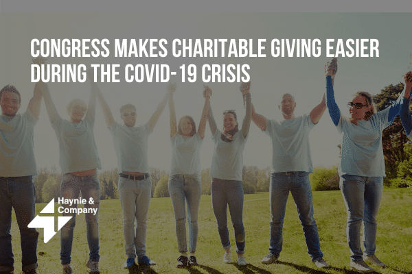 People holding hands celebrating charitable giving during COVID-19 pandemic.