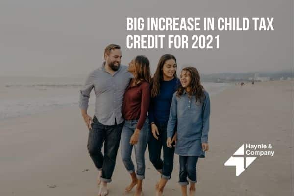 Family walking on the beach, promoting a big increase in child tax credit for 2021.