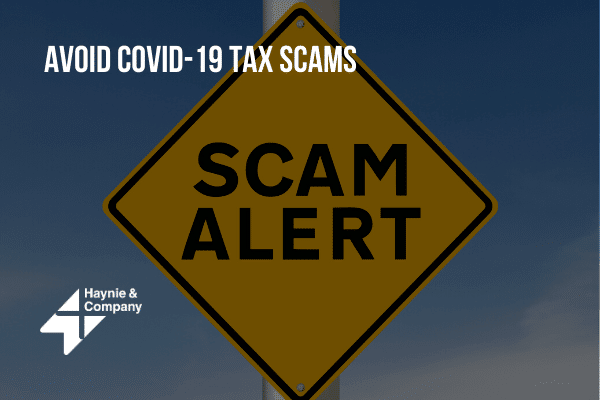 Scam alert sign cautioning against COVID-19 tax scams by Haynie.