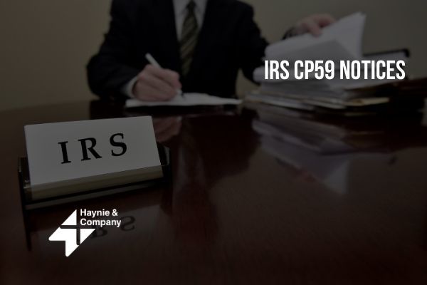 IRS desk with documents and IRS CP59 notices, Haynie logo.