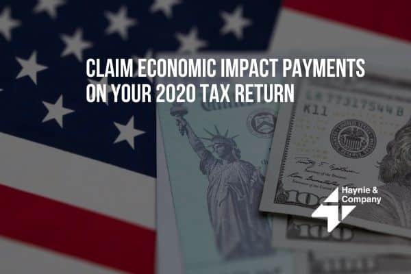 Economic Impact Payments claim ad over US flag and banknotes for 2020 tax return. Haynie logo visible.