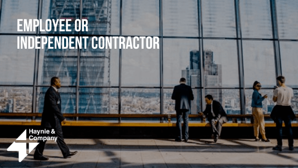 Office workers discussing Employee or Independent Contractor with city skyline background.