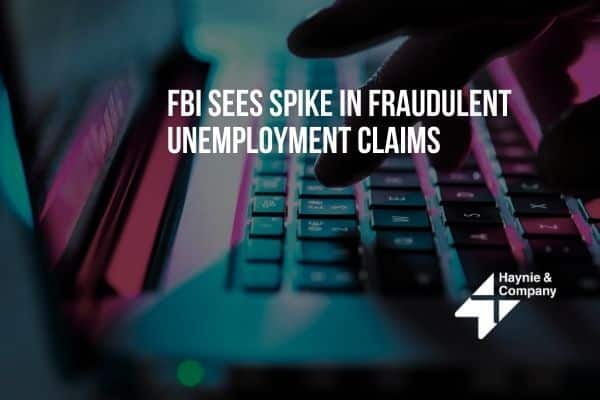 FBI warns of increase in fraudulent unemployment claims; hand typing on laptop. Haynie logo visible.