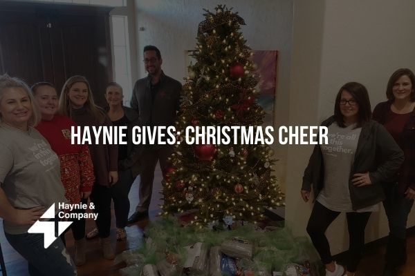 Haynie team spreading Christmas cheer with a decorated tree and gifts.