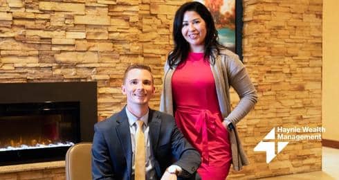 Business professionals in formal attire at Haynie Wealth Management office.