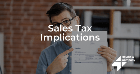 Man holding an invoice with Sales Tax Implications text overlay, Haynie logo displayed.